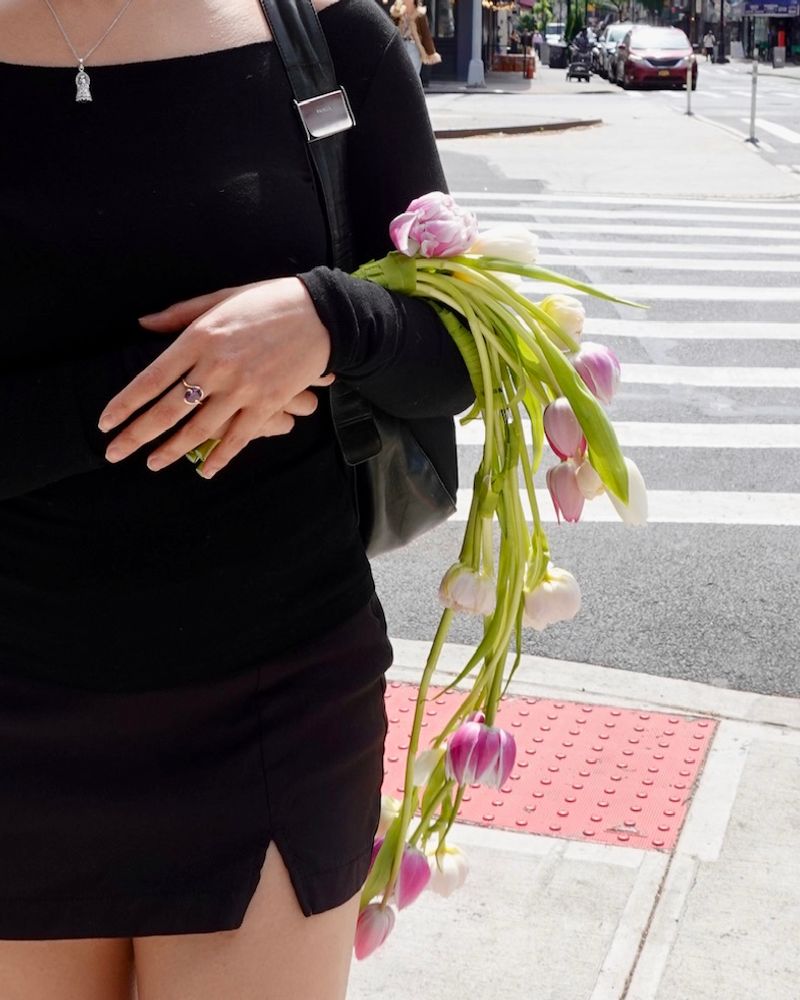 Angelique of 222 florals carrying a bundle of pink and white tulips