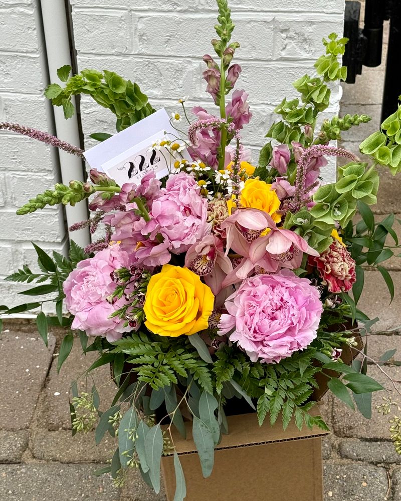 Pink peonies and yellow roses arrangement by 222 Florals