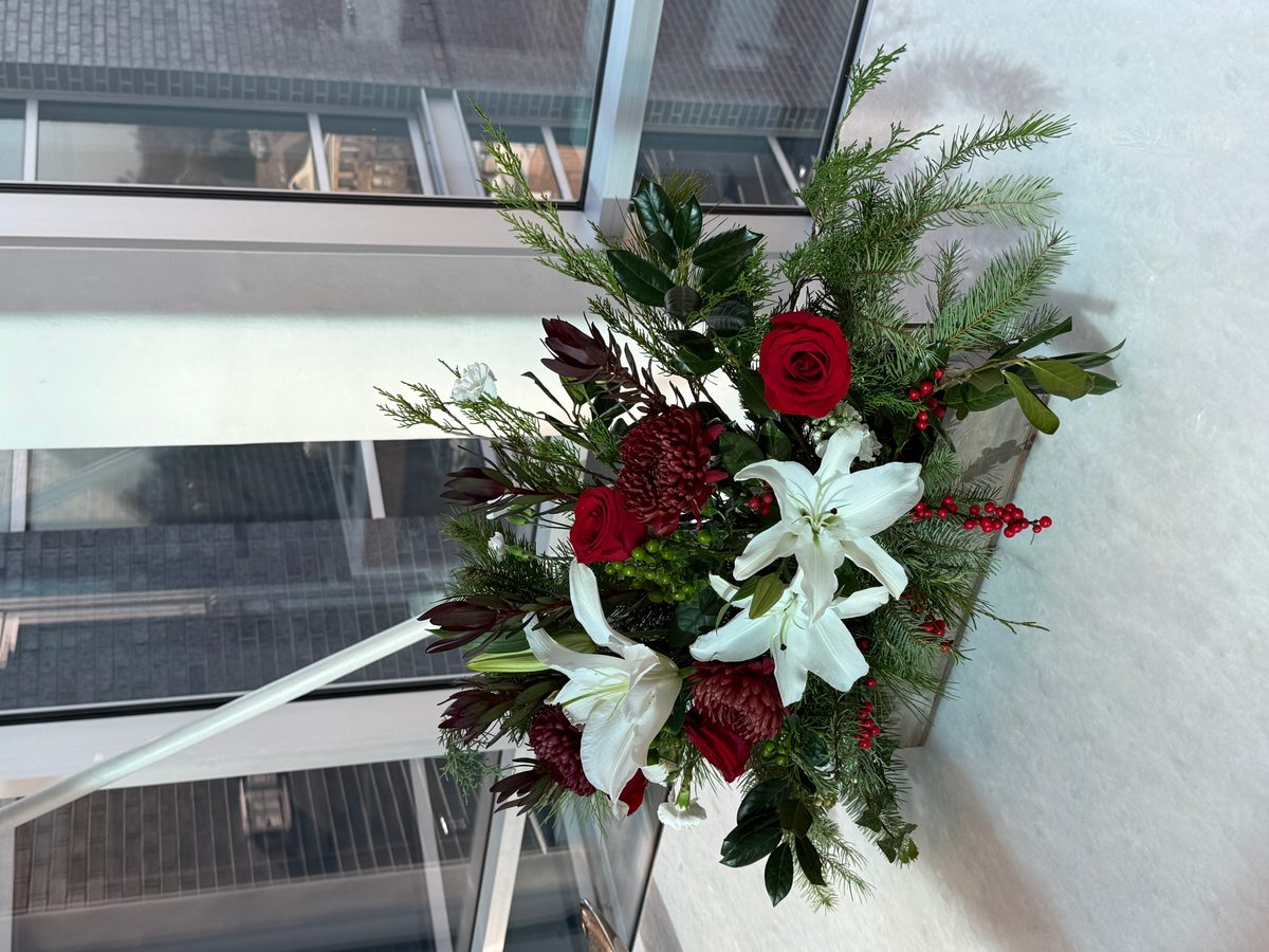 Holiday arrangement with red roses and white lilies