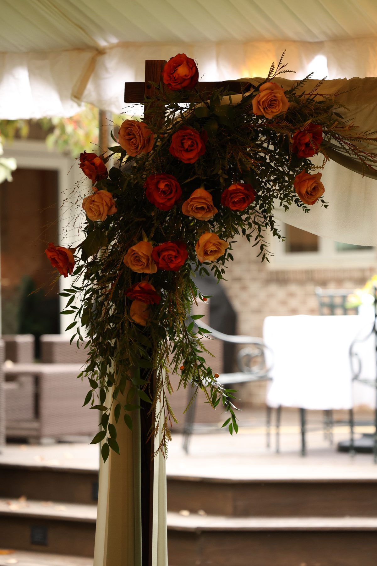 Fall wedding arch with lush greenery and blooms