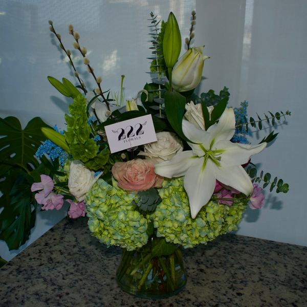 Branded lily and hydrangea arrangement